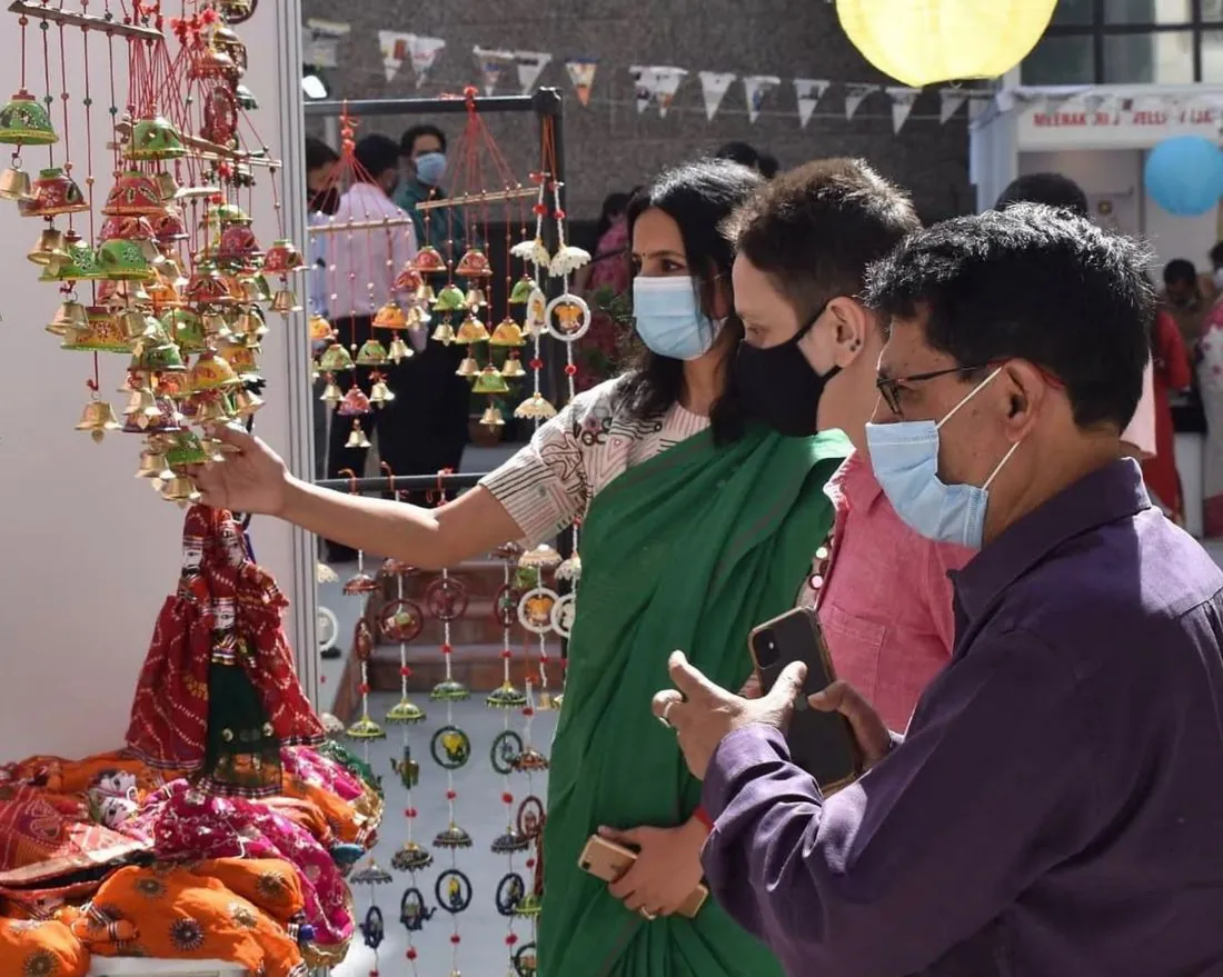 Visitors browsing handcrafted decorations at a stall