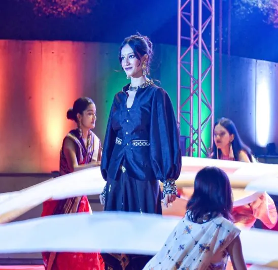 Model in indigo attire on stage