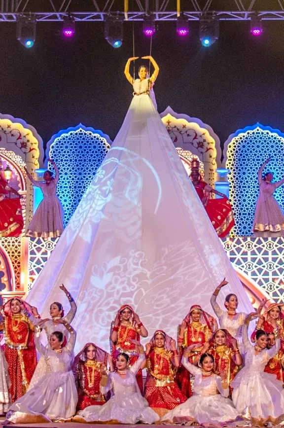 Dancers performing around an illuminated installation