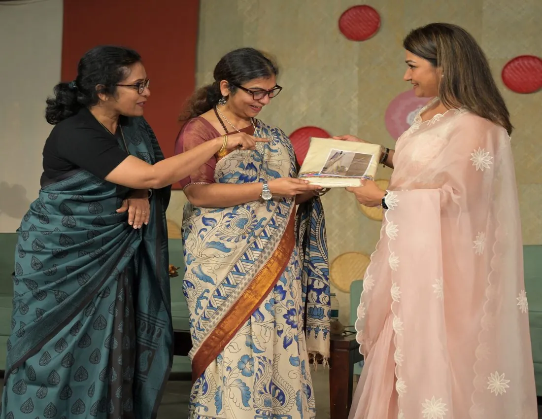 Guests exchanging a memento on stage