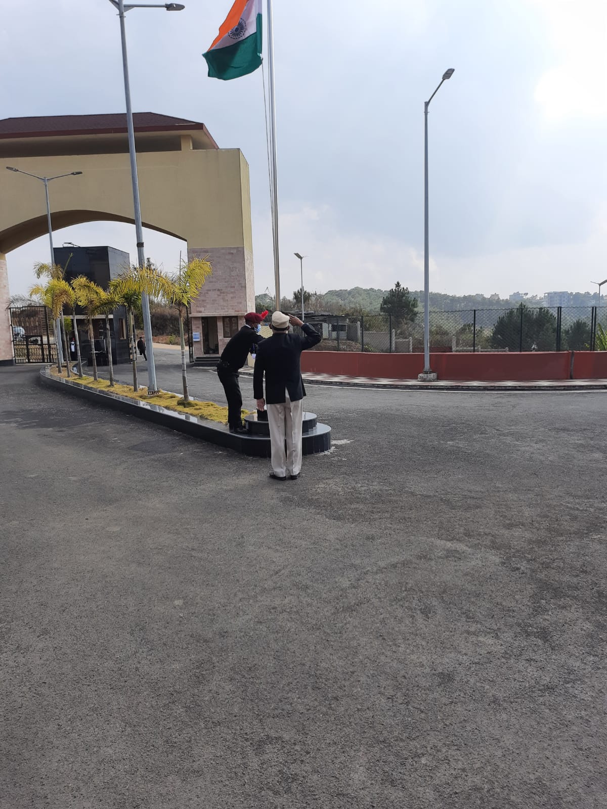 Honorable Director unfurls the flag.
